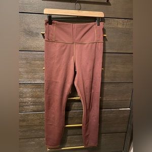 Athleta Persistence Laser Cut 7/8 tight. Size Medium. Color burgundy.